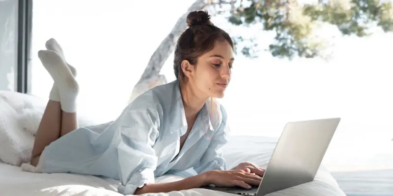 Person working on a laptop in bed